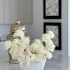 A sophisticated white rose arrangement nestled in a chic vase, perfectly balancing
