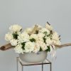 A serene and elegant arrangement delicately nestled in a sophisticated chic vase.