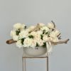 A serene and elegant arrangement delicately nestled in a sophisticated chic vase.