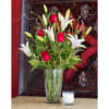 Stargazer lilies fall in love with bright red roses, accented with seasonal