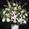 elegant white arrangement with green accents in a mache basket