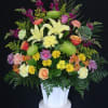 variety of flowers and colors arranged in a mache basket