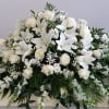 a large, all-white, elegant casket cover for a loved one