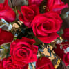 A Dozen Red Roses Arranged Low in a clear vase with Premium