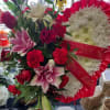 A beautiful standing spray using white gerbera daisies, red carnations, pink lilies