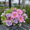 A profusion of purple, pink, lavender and green blooms such as roses