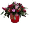 Crimson Bloom Delight is an exquisite arrangement featuring a striking red container