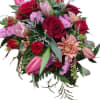 Crimson Bloom Delight is an exquisite arrangement featuring a striking red container