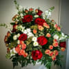 funeral container filled with Roses, spray roses and various filler in beautiful