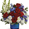 This red, white, and blue arrangement includes red roses, red carnations, miniature
