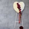 All white mums and red roses with ribbons.