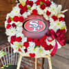 a themed funeral wreath in white and red 49er&#039;s colors featuring the