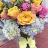 Like an ocean sunset, this bold bouquet of radiant sunflowers and different