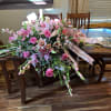 All pink, lilies, Gladiola, snapdragons roses, spray, roses, and greens