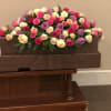 The Pastel memories casket spray features all roses in different shades including