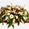 This Crimson tribute has Casablanca lilies, red roses, white roses, stock, wax