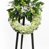 Classic funeral design with tropical greenery and a touch of  daisy