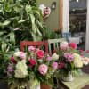 Gorgeous pink or purple roses, blue delphiniums, green hydrangeas, lambs ear, and