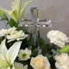 This peaceful all white bouquet features a beautiful crystal cross as the