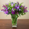 Beautiful arrangement featuring market fresh purple and lavender flowers carefully designed in