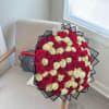 A captivating arrangement of lush roses in radiant red, delicate white, and