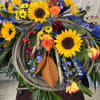 Sunflowers with mums and blue delphinium accented with bandana and rope.