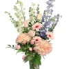 With its soft pinks and cool blues, this elegant floral arrangement is