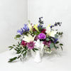 Fresh seasonal flowers arranged in a ceramic angel container. Approximately measures 12&quot;x12&quot;