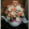 Pretty in pink roses arranged in a beautiful teapot.  (Teapot colors
