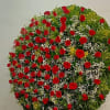 A classy and elegant floral sympathy Wheel with 100 red roses, greens