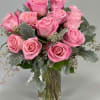1 Dozen light pink roses in a vase with. greenery 