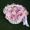 The Enchanted Pink Basket is a delightful arrangement featuring an array of
