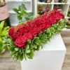 Low and long flowers arrangements with 33+ roses in a square container