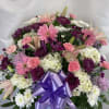 A lovely assortment of pink, white and purple flowers. This basket is