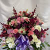 A lovely assortment of pink, white and purple flowers. This basket is