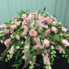 pink casket piece with roses, carnation and larkspur