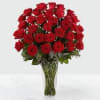 36 Red roses as shown arranged in a vase as shown.
Deluxe, the