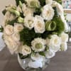 A medley of white mondial roses with luxury accent florals and Ti