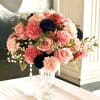 An elegant arrangement of fresh flowers: roses, delicate carnations, and lush dahlias.