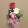3 Beaitiful Roses arranged in a glass vase. Colors may vary