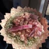 A 50 count light pink rose bouquet added with baby breath around
