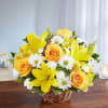 Basket arrangement of yellow roses, Asiatic lilies and alstroemeria and white daisy