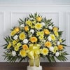 Floor basket arrangement of yellow roses, cremones, carnations, and daisy poms; white
