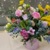 Shades of pinks and purples highlight this arrangement with little pops of