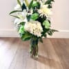 Featuring White Hydrangea, White Lily&#039;s, White Poms, Tinted Green Carnations, and Fill