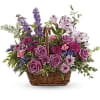 This lush lavender rose arrangement is a basket of beauty to brighten