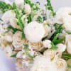 This bouquet? Straight-up timeless elegance. Soft whites, creamy roses, and fresh green