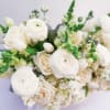 This bouquet? Straight-up timeless elegance. Soft whites, creamy roses, and fresh green
