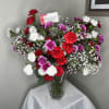 A vibrant arrangement of mixed carnations paired with the delicate beauty of