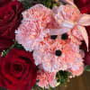 Arragment, made of pink carnations and red roses.